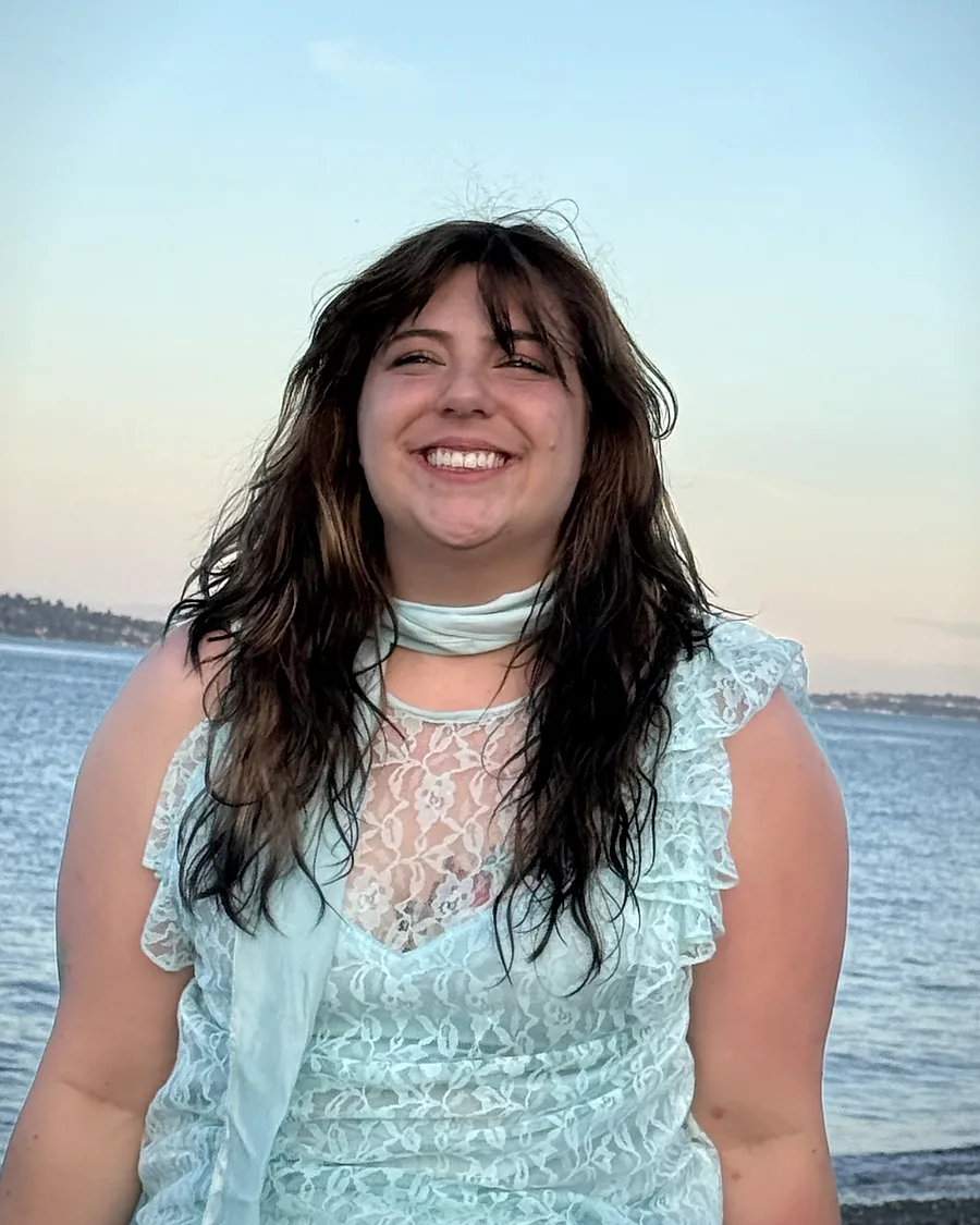 Miranda Sita, founder of Bainbridge Death Support, laughing beside the Salish Sea.